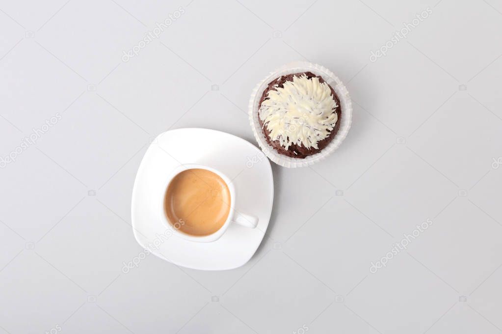 Classic style espresso shot with chip muffin and coffee beans on white background.
