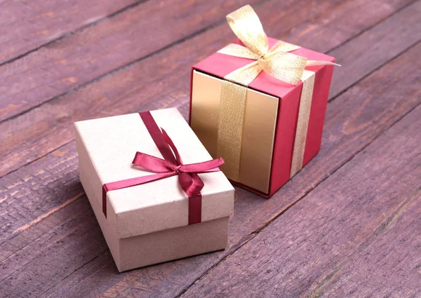 Red and gold gift box on wood background. — Stock Photo, Image