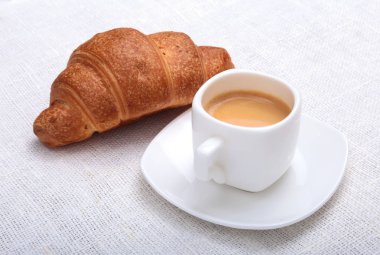 Çıtır taze kruvasanlar ve fincan kahve espresso bir beyaz arka plan, sabah kahvaltı, seçici odak