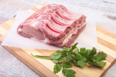 Çiğ domuz eti, baharat ve fesleğen kesme tahtası üzerinde. Hazır yemek pişirmek için.