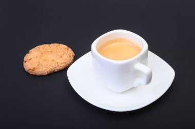 Klasik espresso ile ev yapımı kek siyah arka plan üzerine beyaz Kupası'nda. Seçici odak.