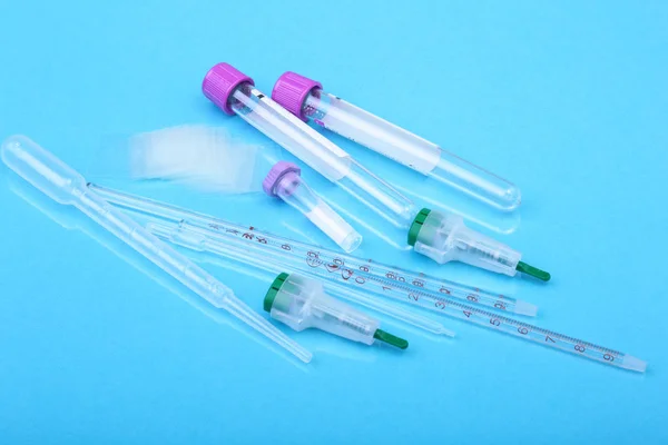 Set of laboratory supplies for blood test. Petri dish, scarifier, Spectrophotometer cuvettes, blood test-tube. Selective focus.