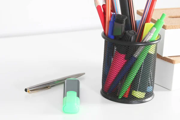 Closeup of white desktop with notepads, pen and other items. Selective focus. — Stock Photo, Image