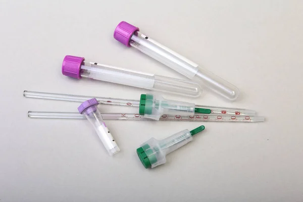 Set of laboratory supplies for blood test. Petri dish, scarifier, Spectrophotometer cuvettes, blood test-tube. Selective focus.