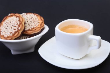 Klasik espresso ile ev yapımı kek siyah arka plan üzerine beyaz Kupası'nda. Seçici odak.