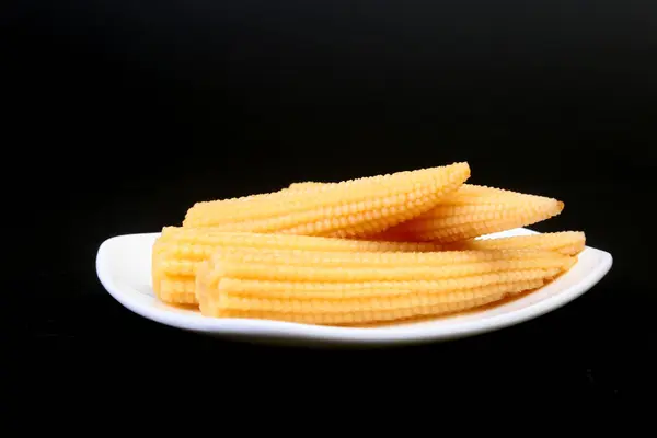 Mini Corn cob preserved on plate on wooden board. — Stock Photo, Image