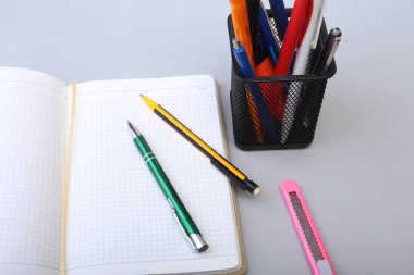 Açık boş sayfa defter ve kalem beyaz masada.