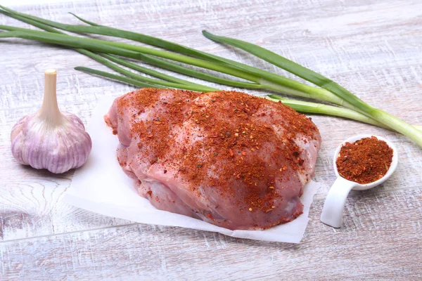 Pork steaks with fat. Meat is on wooden board with spice as pepper and green spring onion. Ready for cooking. Selective focus. — Stock Photo, Image