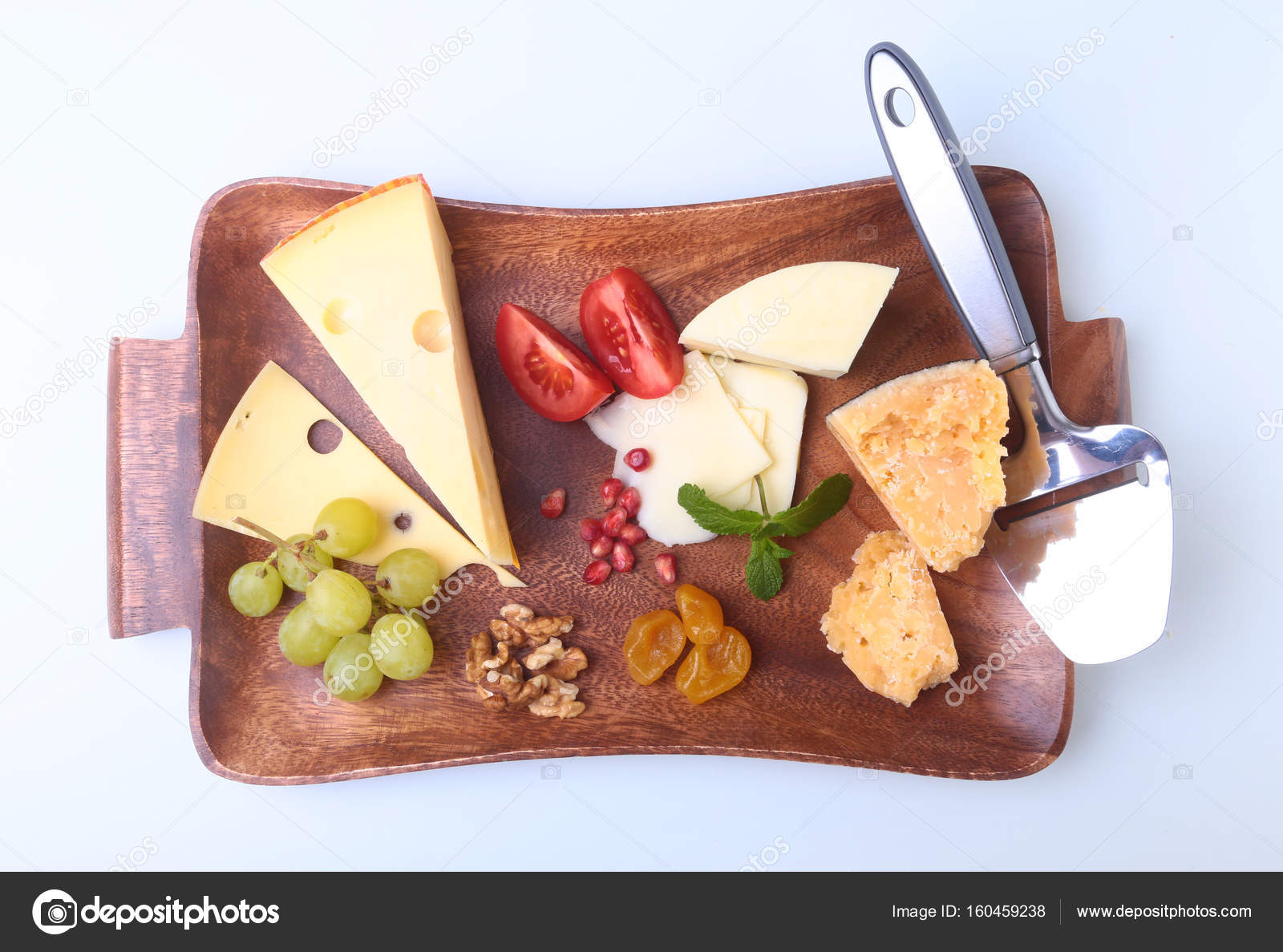 Assortment Of Cheese With Fruits Gs Nuts And Knife On A Assortment Of Cheese With Fruits Gs Nuts And Knife On A Wooden Serving Tray Photo By Vicby