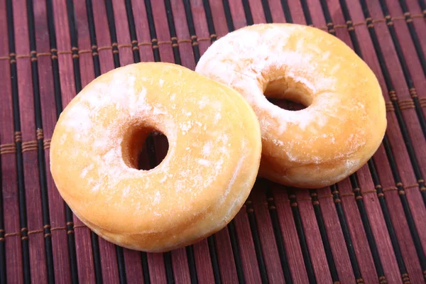 Homemade Doughnuts with Jelly filled and powdered sugar on Bamboo tablecloth. Selective focus. — Stock Photo, Image