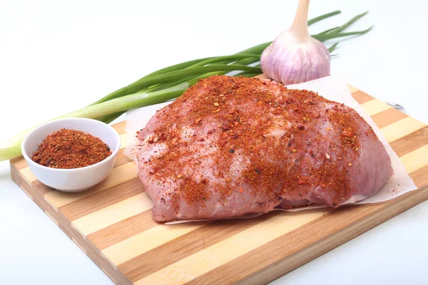 Pork steaks with fat. Meat is on wooden board with spice as pepper and green spring onion. Ready for cooking. Selective focus. — Stock Photo, Image