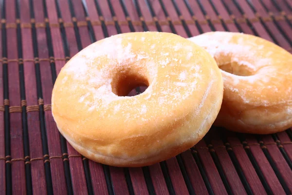 Homemade Doughnuts with Jelly filled and powdered sugar on Bamboo tablecloth. Selective focus. — Stock Photo, Image