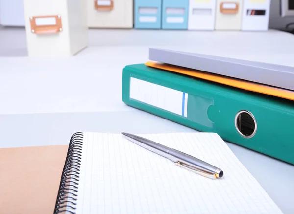 Folder file, note and pen on the desk. blurred background.