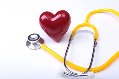 Tıbbi steteskop ve kırmızı kalp beyaza izole edilmiş.