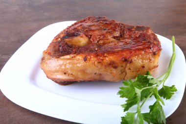 ahşap masa üzerinde soslu ızgara domuz pirzolası.