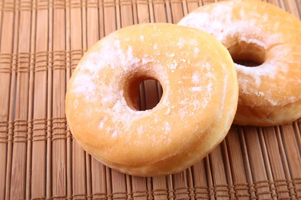 Homemade Doughnuts with Jelly filled and powdered sugar on Bamboo tablecloth. Selective focus. — Stock Photo, Image