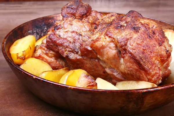 Juicy pork neck chops are grilled with potatoes on a stone Background. — Stock Photo, Image