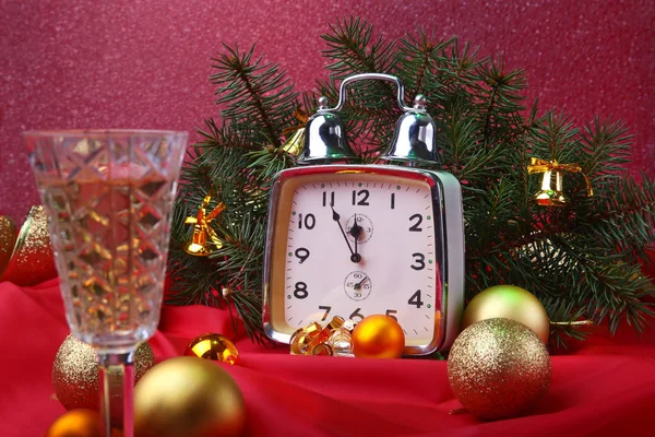 Christmas clock and glass champagne wine. New Years Decoration with gift boxes, christmas balls and tree. Celebration Concept for New Year.