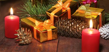 Noel dekorasyon hediye kutuları, kırmızı mumlar, Noel ağacı ve renkli topları. Seçici odak.