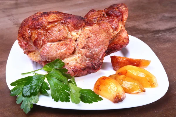 Beyaz bir tabak patates ile sulu domuz boyun eti ızgara.