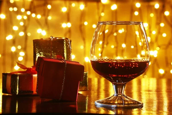 Whisky, Cognac, Brandy und Geschenkbox auf Holztisch. Festkomposition auf hellem Hintergrund. — Stockfoto