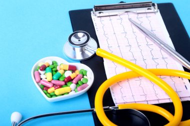 Stetoskop, Rx reçeteli ve renkli ürün yelpazesine hap ve kapsül plaka üzerinde.