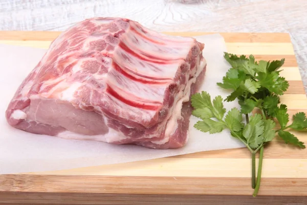 Raw pork chops, spices and basil on cutting board. Ready for cooking. — Stock Photo, Image