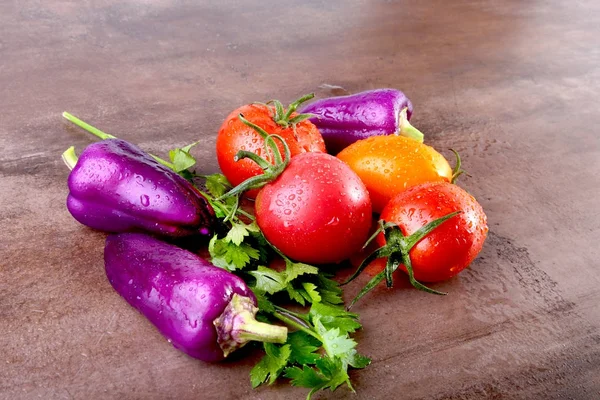 Assorted vegetable with purple exotic color bell peppers and tomatoes isolated on stone background. — Stock Photo, Image