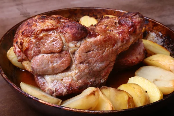 Juicy pork neck chops are grilled with potatoes on a stone Background. — Stock Photo, Image