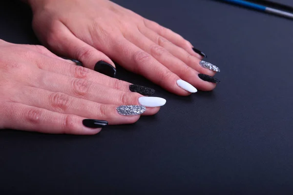 Black, white Nail art manicure. Holiday style bright Manicure with sparkles. Beauty hands. Stylish Nails, Nail Polish