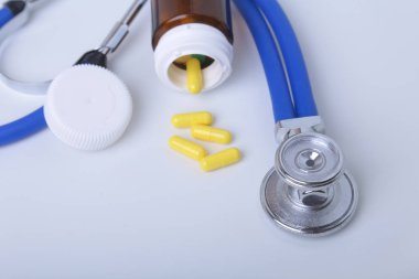 asorted pils ve beyaz arka plan üzerinde bir stetoskop