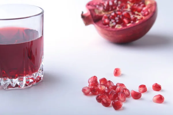 Vidrio con jugo de granada Semillas de granada y hermosa granada madura sobre fondo blanco con lugar para espacio de copia . — Foto de Stock