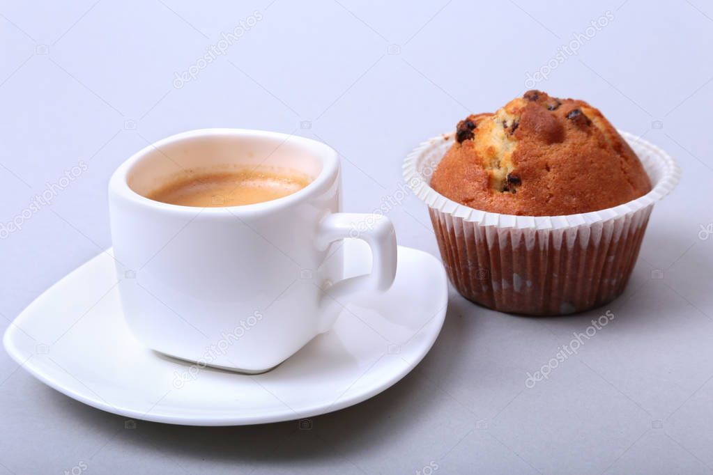 Classic espresso in white cup with homemade cake and chocolate on white background.