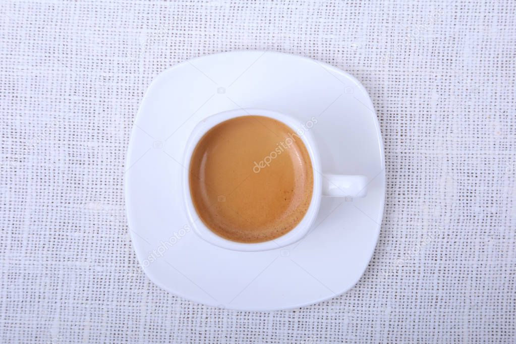 Classic espresso in white cup on white background. Top view.
