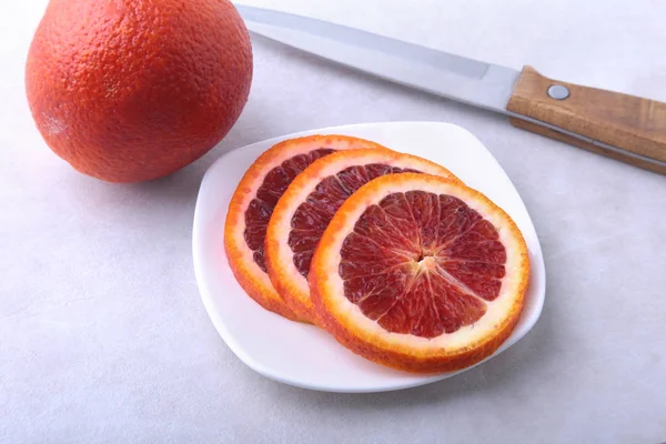 Des oranges. Trancher l'orange et le citron sur une assiette blanche. Vue du dessus . — Photo