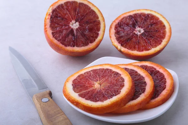 Orange fruit. Orange and lemon slice on white plate. Top view.