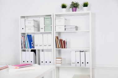 Masalar, sandalyeler ve kütüphaneler ile modern ofis iç