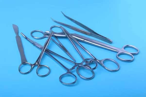 Хирургические инструменты и инструменты, включая скальпели, щипцы и пинцет, расположенные на столе для операции. — стоковое фото