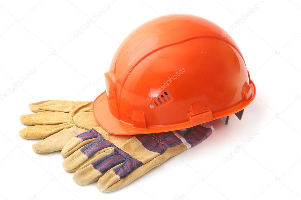 Orange hard hat, safety gloves on white background. Safety helmet.