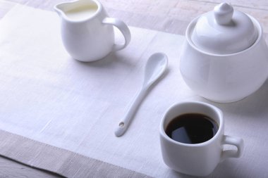 Bir fincan sıcak kahve espresso, kahve çekirdekleri, sürahi süt ve şeker kopya alanı için beyaz arka plan üzerine bir kase. Kahve kavramı.