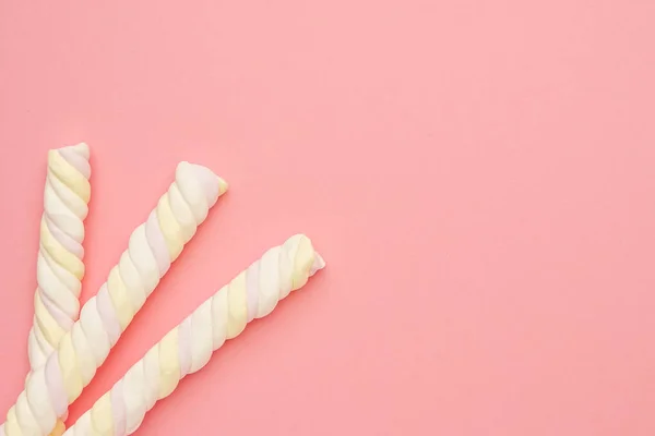 Rosa Hintergrund mit farbigen langen Marshmallows, köstliche Süßigkeiten flach gelegt — Stockfoto