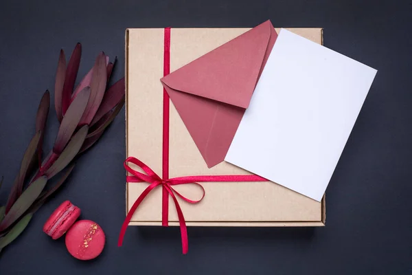 Подарункова картка та подарунок у коробці з атласною стрічкою на темному фоні — стокове фото