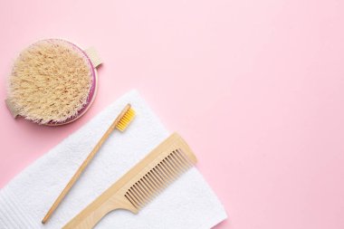 Eko ahşap diş fırçası, tarak ve fırça. Pembe arka planda, telif alanı, banyo ve spa aksesuarlı kuru masaj için.