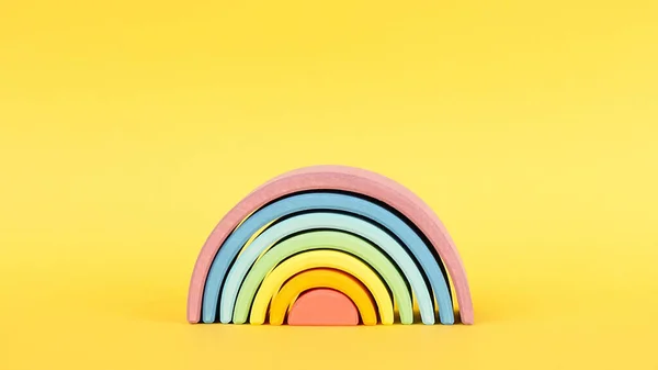 Farbenfroher Waldorfhölzerner Regenbogen auf gelbem Hintergrund, Montessori-Pädagogik — Stockfoto