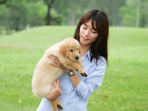 Femme asiatique jouant chiot chien dans le parc — Photo