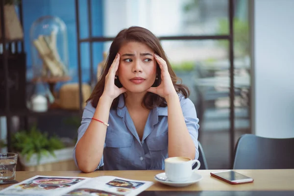 Asian woman unhappy with confuse face stress in coffee shop cafe