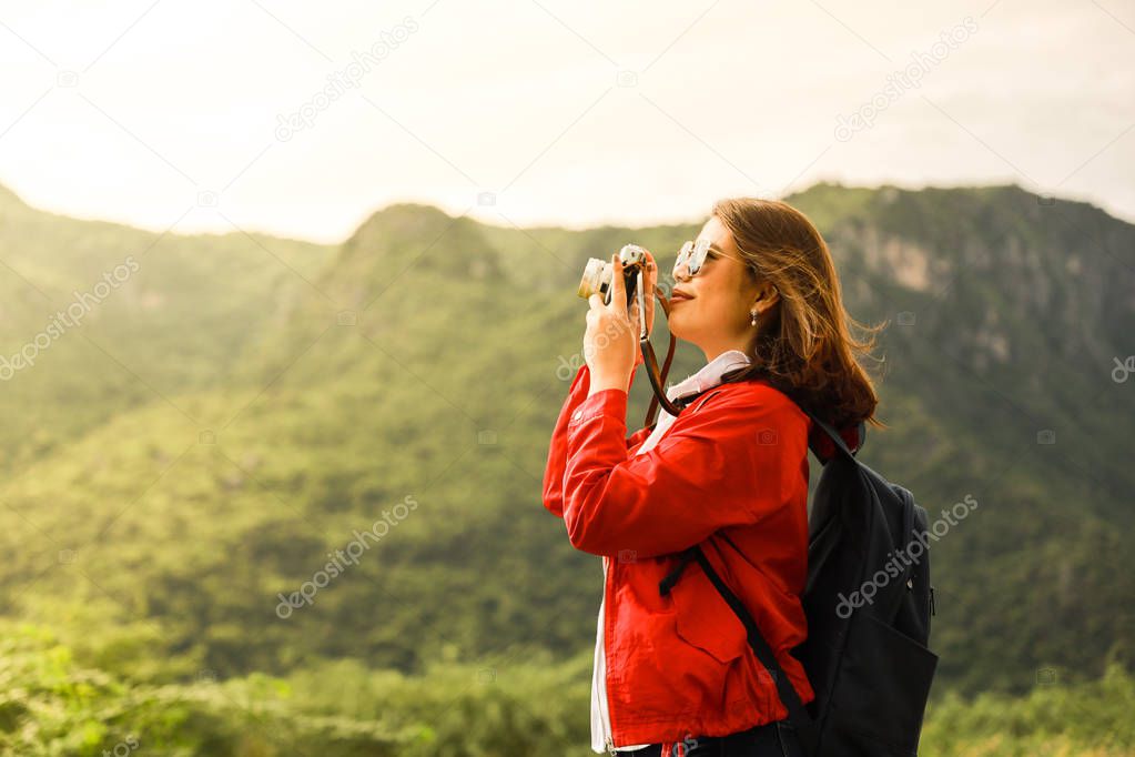 Young Asian woman in red choth travel in the mountain with vinta