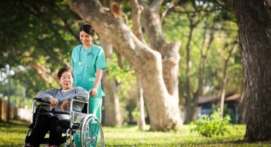 Asian senior woman sitting on the wheelchair  with woman in doct