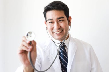 Asian man in Doctor uniform on white background in hospital