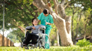 Asian senior woman sitting on the wheelchair  with woman in doct